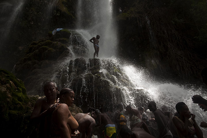 24 Hours in Pictures: Voodoo pilgrims at a waterfall believed to have purifying powers in Haiti