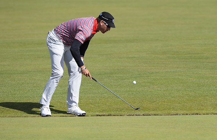 British Open Saturday: Ricky Barnes retrieves his ball from the Swilken Burn
