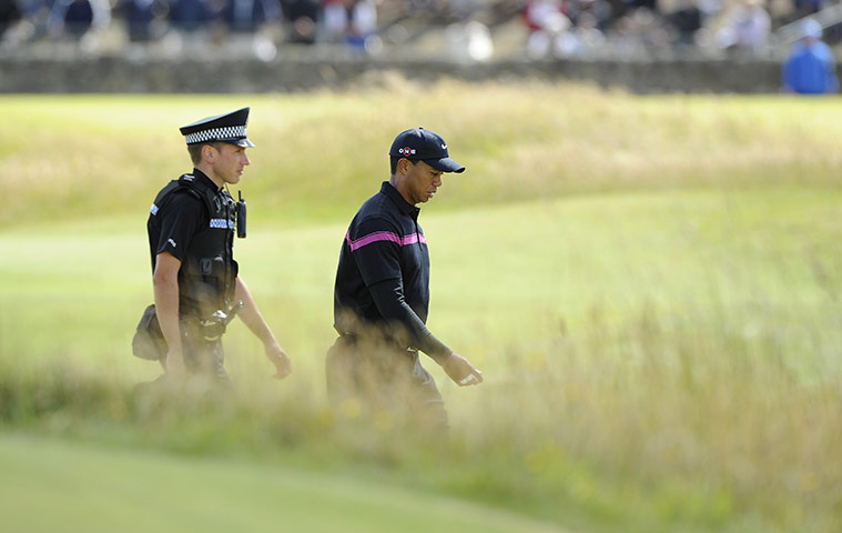 British Open Saturday: Tiger Woods has a police escort as he makes his way down the 2nd
