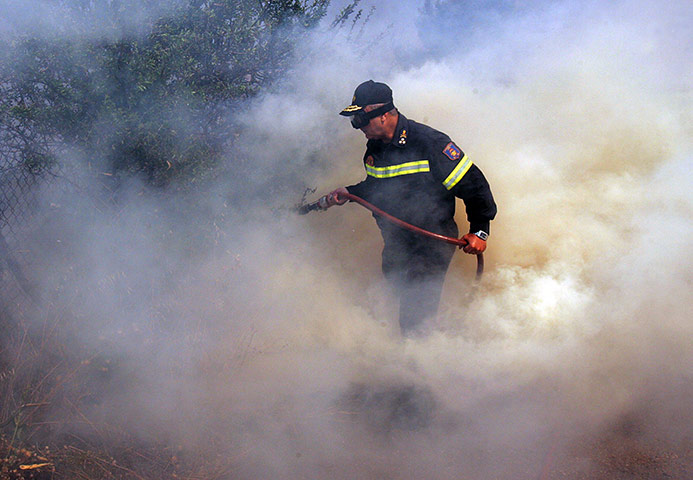 Greece wildfire: A firefighter battles blazes near the village of Varnava