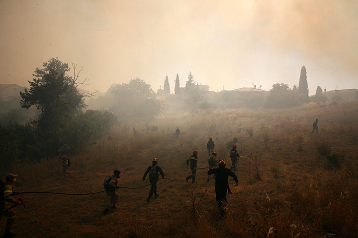 24 hours in pictures: Firefighters and residents try to extinguish a fire in Mikrochori village