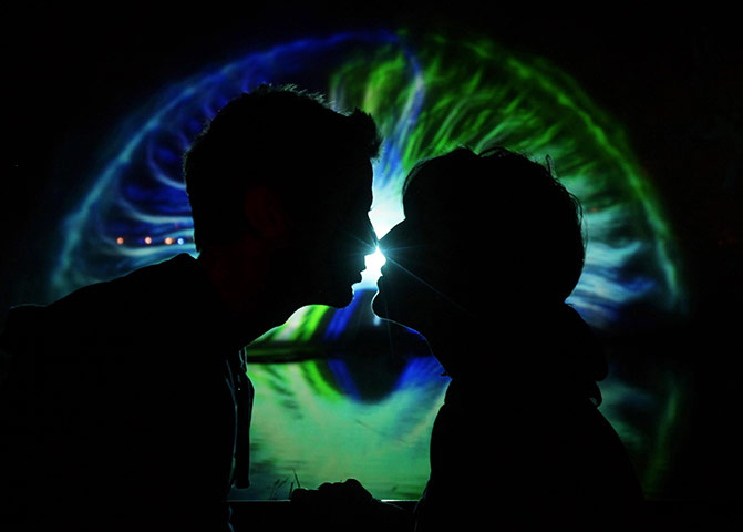 Latitude festival: A couple kiss in front of a 3D water projection displayre