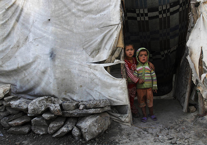 24 hours in pictures: Kabul, Afghanistan: Children stand in front of their home