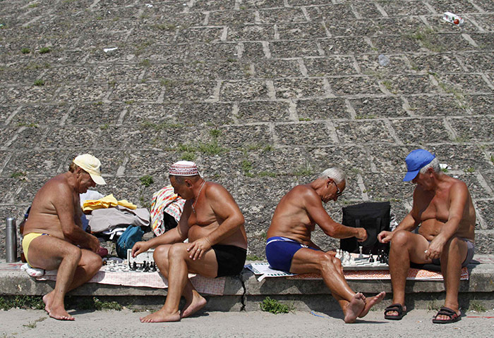24 hours in pictures: Kiev, Ukraine: Men play chess on a public beach