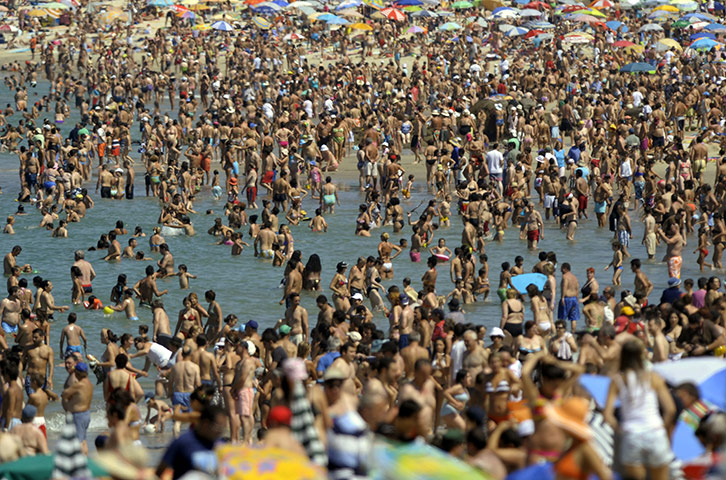 24 hours in pictures: Vigo, Spain: People enjoy the sunny weather on Samil beach