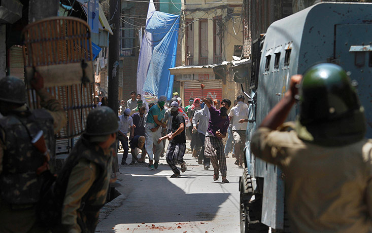 24 hours in pictures: Kashmiris throw stones at paramilitary soldiers during a protest in India