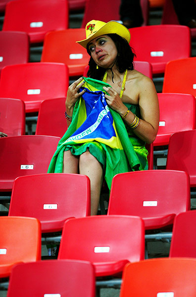 Netherlands versus Brazil: Dejected Brazil fan sits in the stands