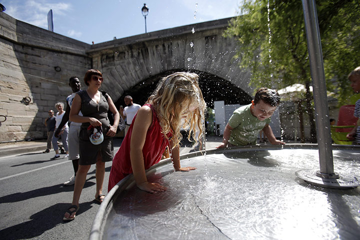 Paris Plage: Children play at a water fountain on the right bank of the River Seine