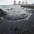 Dalian oil fire in China: Oil washes ashore at Dalian's Port in Liaoning province