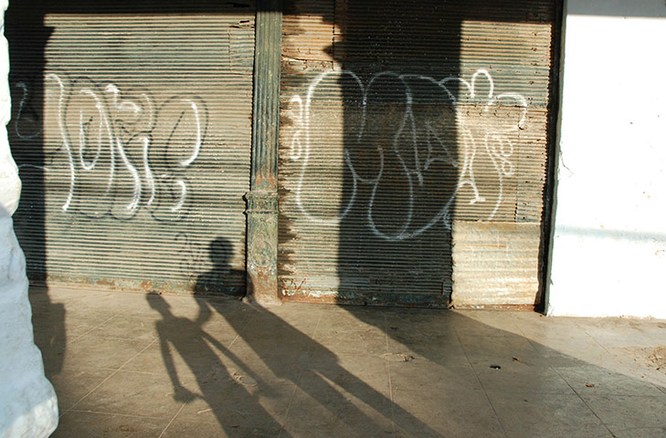 24 hours in pictures: The shadows of two people are seen on a door in Havana