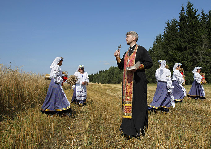 24 hours in pictures: Orthodox priest prays during celebrations of the start of harvesting 