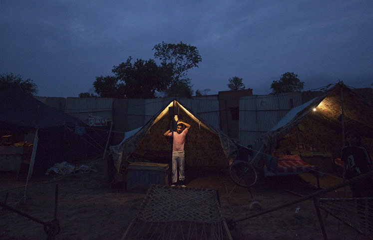 24 hours in pictures: A performer in his tent before the circus in Islamabad