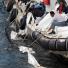Dalian Oil Spill: Workers on a boat collect crude oil in the sea near Dalian