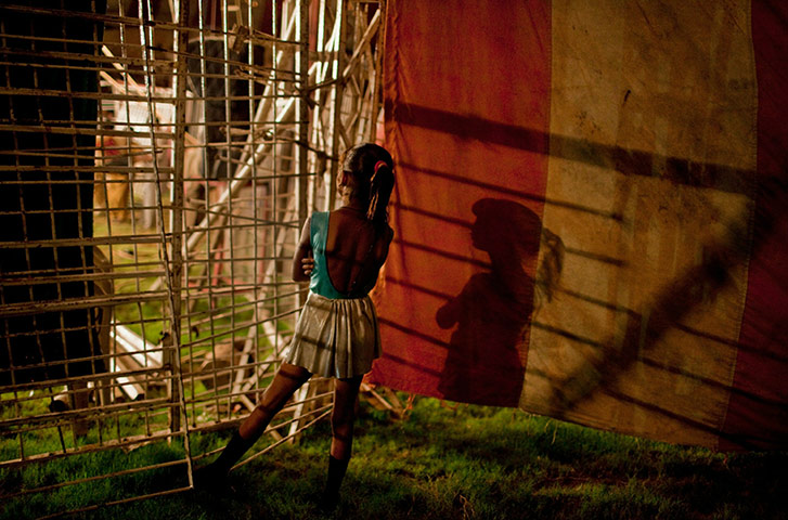 24 hours in pictures: A young circus performer from the Jan Baz troupe, Islamabad, Pakistan