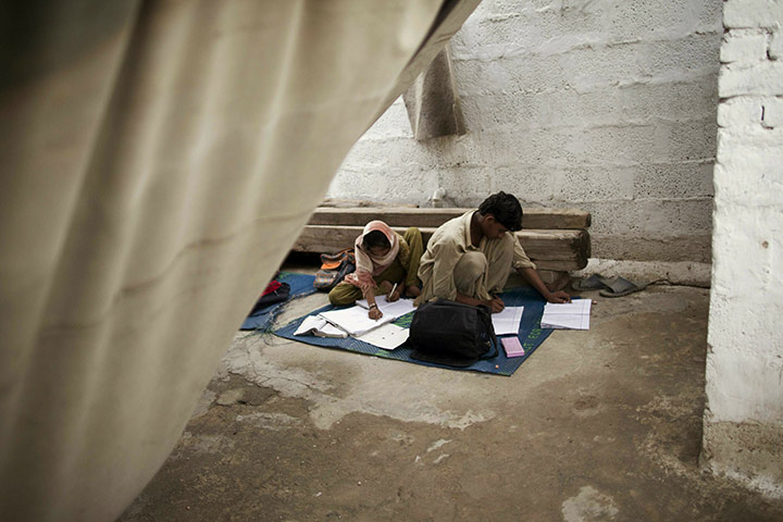 24 hours in pictures: Pakistani pupils do their homework in a school in a poor neighbourhood