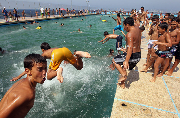 24 hours in pictures: Algerian children swim at the pool in the centre of Algiers