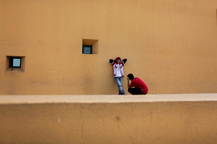 24 hours: A Palestinian boy takes a picture of his friend Gaza City