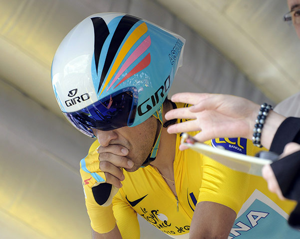 Tour de France time trial: Spanish rider Alberto Contador signs himself before the start of the race