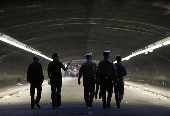 Love Parade: Police officers and journalists walk through the tunnel