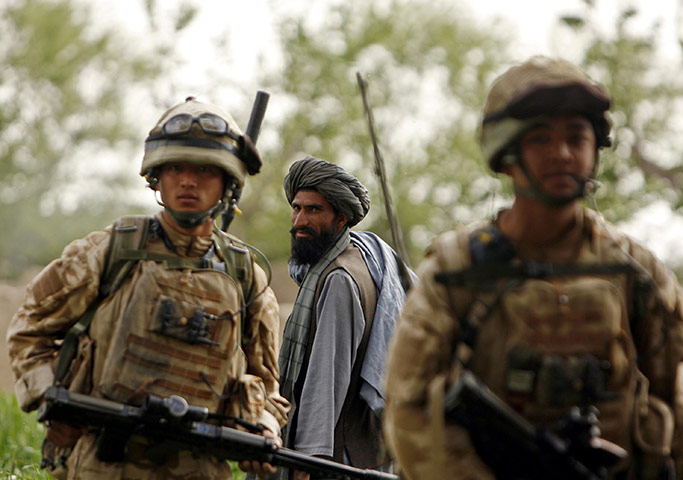 Afghanistan: 27 March 2009: An Afghan man watches British Gurkhas on foot patrol
