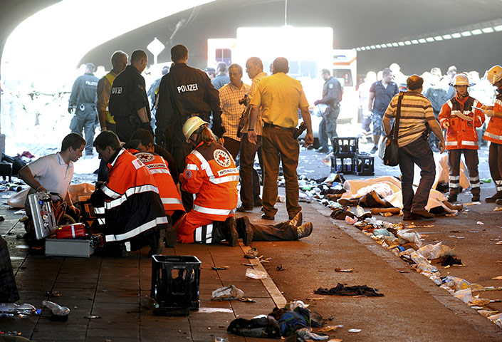 24 hours in pictures: Duisburg, Germany: Rescue workers attend an injured person 