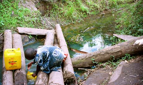 A child collects water in Uganda