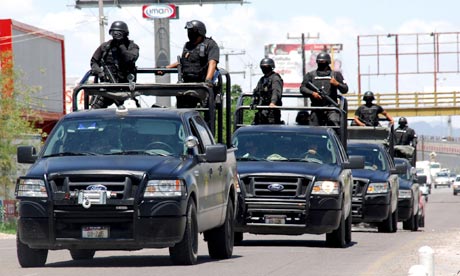 Police officers patrol a street in Torreon, Mexico after gunmen killed 17 people at a party