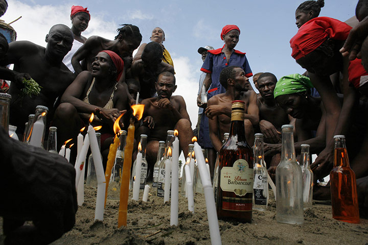 Voodoo in Haiti: Voodoo believers light candles during a mass ritual 