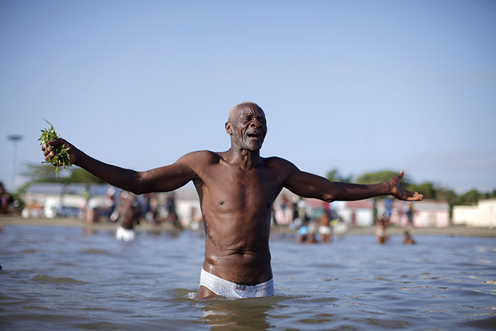 Voodoo in Haiti: A voodoo believer prays during a mass ritual to clean souls