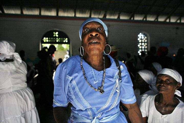 Voodoo in Haiti: A voodoo believer prays inside a church during a religious ceremony
