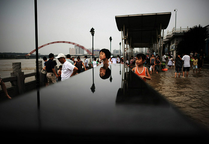 24 hours in pictures: Serious Floods Struck Regions Of China, Killing Over 700