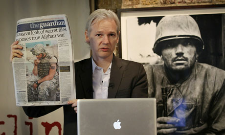 Julian Assange with a copy of the Guardian