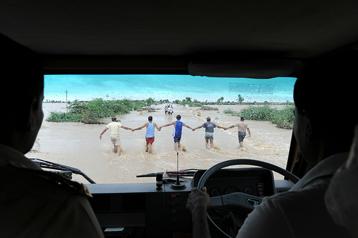 24 hours in pictures: An emergency vehicle follows Ahmedabad e