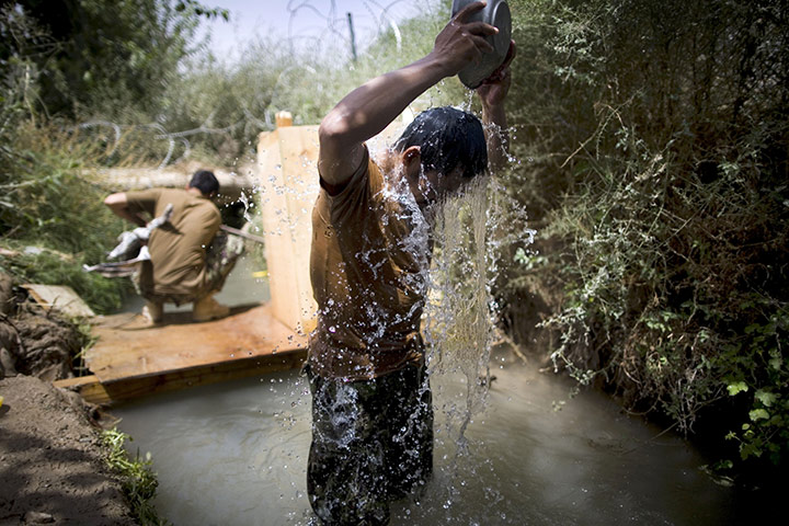 24 hours in pictures: Arghandab Valley, Afghanistan: An Afghan National Army soldier washes