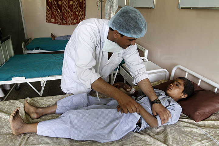 Sangin incident: A medic helps a boy at a hospital in Kandahar