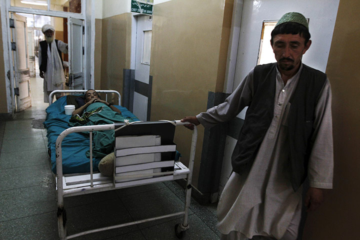 Sangin incident: A man stands next to a bed at a hospital in Kandahar