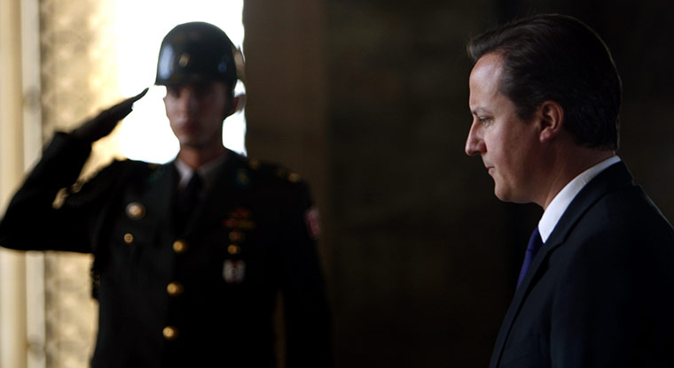 David Cameron on tour: 26 July: David Cameron during a wreath-laying ceremony