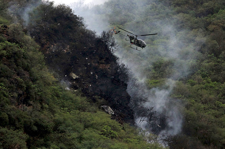 Plane crash in Pakistan: A helicopter flies over the wreckage of a passenger plane