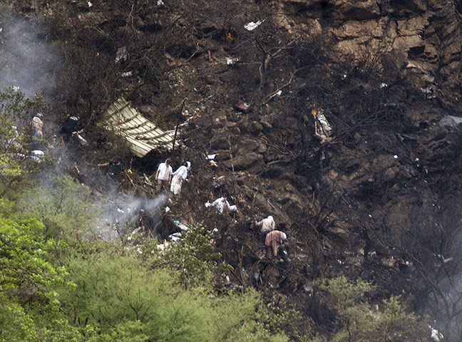 Plane crash in Pakistan: Pakistani rescue workers look for survivors at the site of a plane crash
