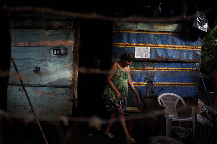 24 hours in pictures: Nicaragua,: A woman leaves her shack for work at the municipal garbage dump