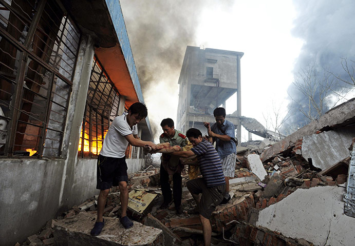24 hours in pictures: Nanjing, China: A man injured during an explosion at a plastics factory