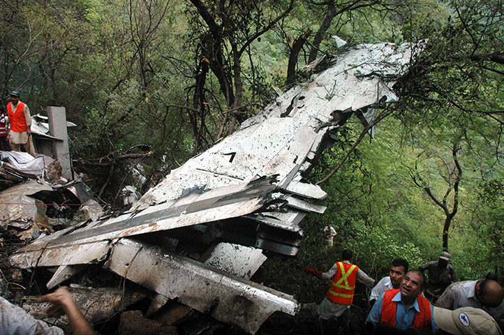 24 hours in pictures: Islamabad, Pakistan: Rescuers surround the wreckage of a plane