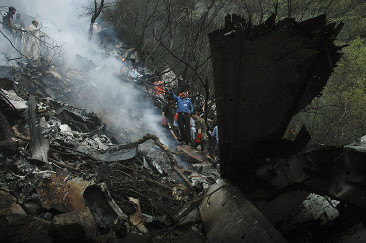 Plane crash in Pakistan: Pakistani rescue workers examine the site of a plane crash