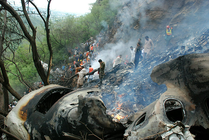 Pakistan plane crash: Pakistani rescue workers search for survivors in the wreckage