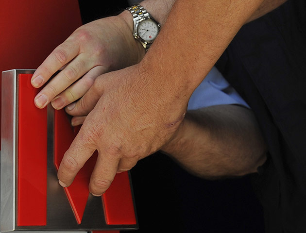 Metro Bank: Workers attach a door handle to a branch of Metro Bank in central London