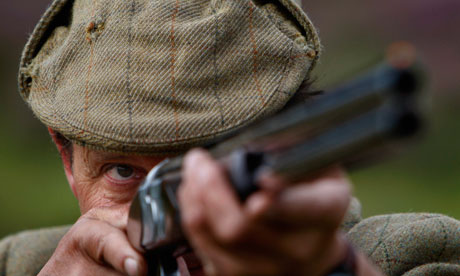 A shooter watches a grouse