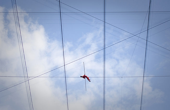 24 Hours in Pictures: Adili Wuxor lies on a tightrope on top of China's National Stadium