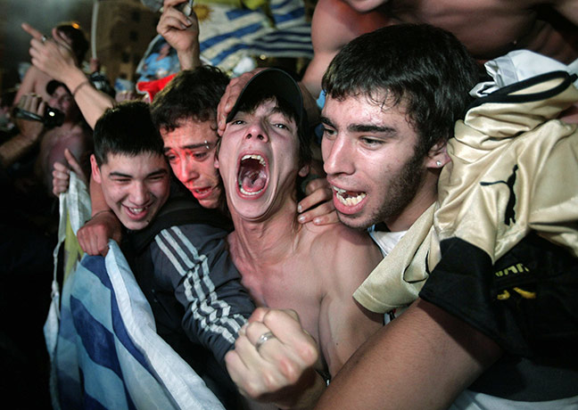 24 Hours in Pictures: Uruguayan fans celebrate after defeating Ghana in a penalty shootout