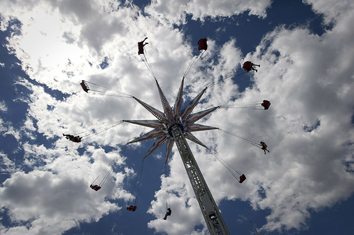24 Hours in Pictures: Kids fly through the air on an amusement ride at Coney Island