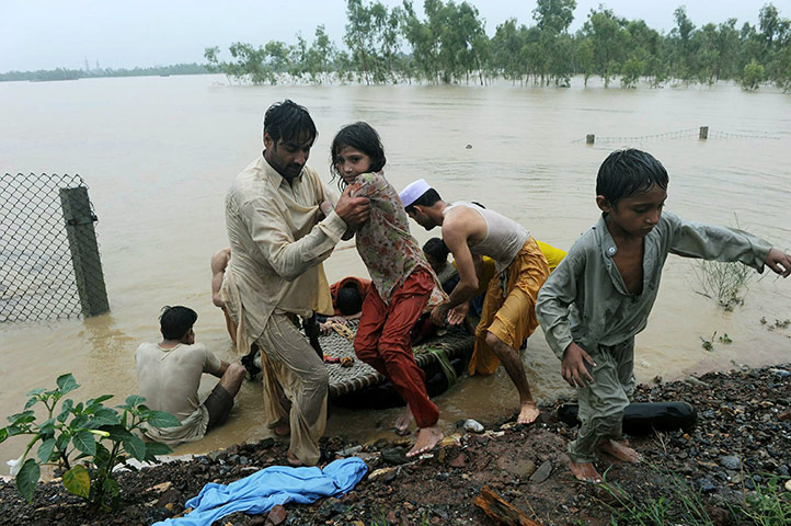 Pakistan floods: Pakistani local residents scramble to safety in flood-hit Nowshera 